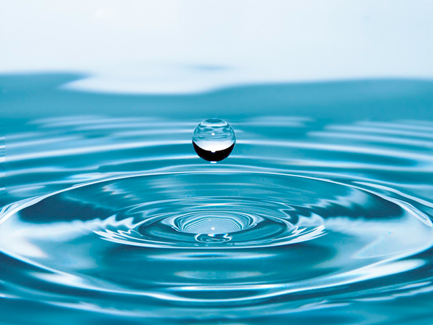 blue water drop falling into water